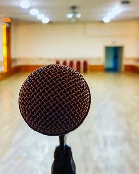 Singer's microphone closeup on stage in an empty hall. Stock Photos