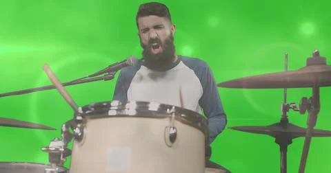 Singing bearded drummer playing drum kit in green screen studio, wearing raglan Stock Photos