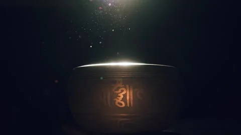 Singing bowl in a beam of light Видео 258836044