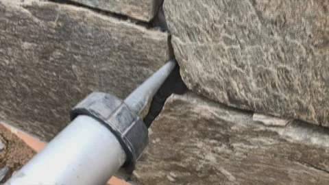 Singing gaps between the wild stone on the cladding of the foundation. Facing Video stock 239267407