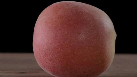 Single apricot placed on a table. Camera smoothly slides toward the apricot Stock Footage 284565274