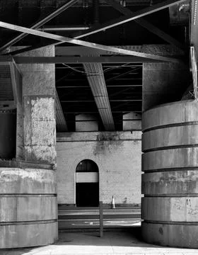 A single archway viewed between giant sandstone pillars Stock Photos