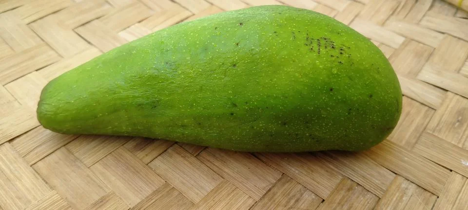 Single Avocado on Bamboo Surface Stock Photos