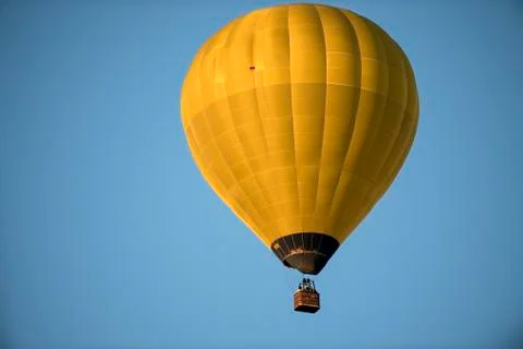 A single balloon on a blue sky Stock Photos