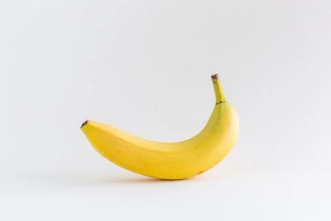 A single banana on a white background, with copy space Stock Photos