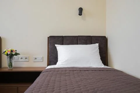 Single bed white pillow nightstand Stock Photos