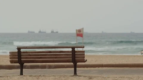 Single bench facing a beach 스톡 동영상 81904870
