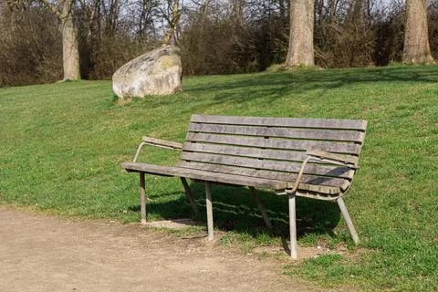 Single bench in a park Stock Photos