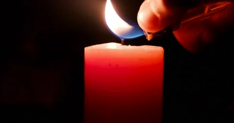 A single big red candle flame burns and goes out, isolated on a black background Stock Footage 232319770