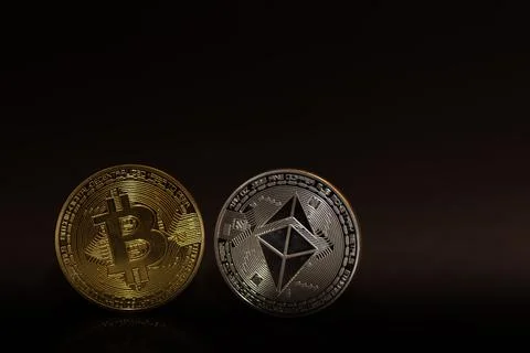 Single bitcoin and ether coin on black background bottom Stock Photos