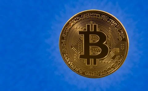 Single bitcoin with blue cloud background Stock Photos