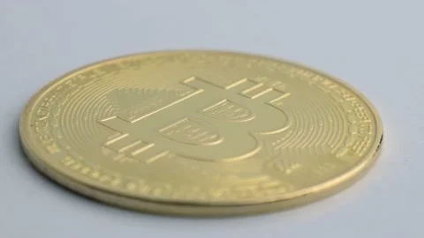 Single bitcoin BTC coin rotating on white background, close-up shot. Blockchain Stock Footage 170853629