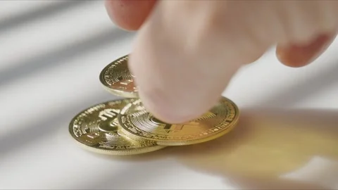 Single Bitcoin Pile Forming Under Moving Blind Lines on Desk Stock Footage 346380369