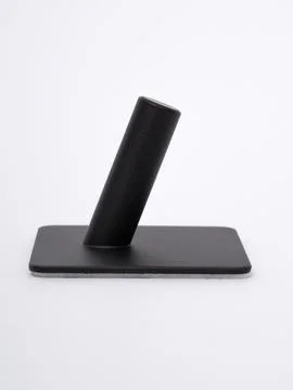 Single black adhesive wall hook angled view Stock Photos