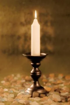 Single black candlestick and white candle Stock Photos