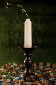 Single black candlestick and white candle Stock Photos