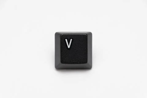 Single black keys of keyboard with different letters V Stock Photos