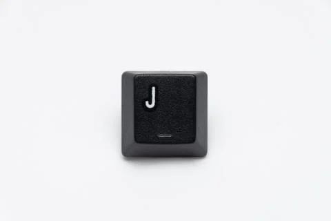 Single black keys of keyboard with different letters J Stock Photos