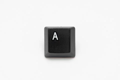 Single black keys of keyboard with different letters A Stock Photos