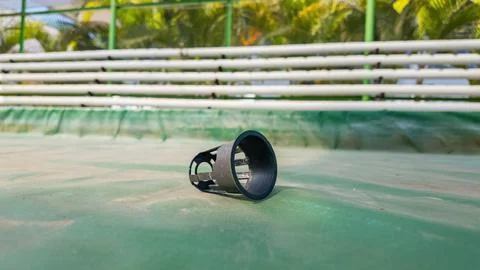 Single black plastic net pot for hydroponics on a green surface Photos
