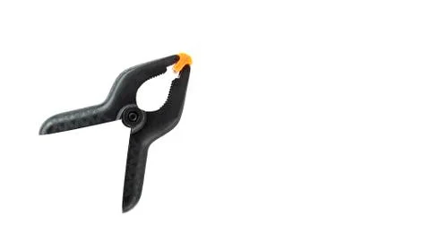 Single black plastic spring clamp isolated over white background Stock Photos