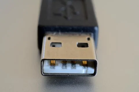 Single, black USB plug closeup. Shallow depth of field. Stock Photos