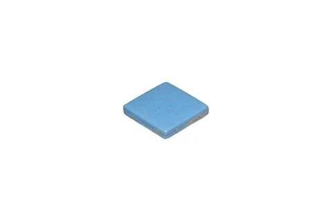 A single blue ceramic mosaic tile is isolated. Stock Photos