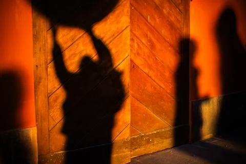 Single blurred human shadow on warm textured wall Stock Photos