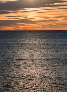Single Boat on Ocean at Sunset 스톡 사진