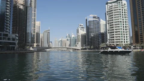 A single boat sailing on the river in the middle of Dubai. Stock Footage 234946393