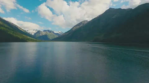 Single boat on the surface of an ideal mountain lake Stock Footage 66860099