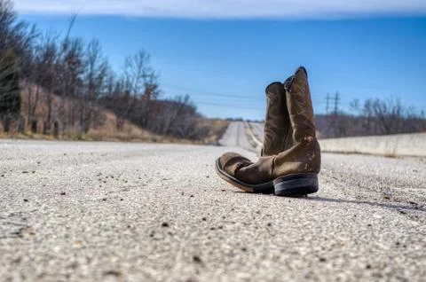A Single Boot On An Abandoned Highway 写真素材