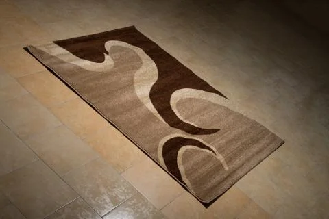 Single brown carpet folded on floor Stock-Fotos