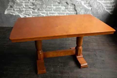 Single brown table with empty surface and carved legs in the loft interior Stock Photos