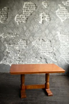 Single brown table with empty surface and carved legs in the loft interior room Stock Photos
