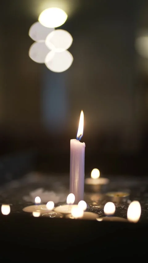 Single Burning Candle in Dim Religious Setting Stock Footage 312747346