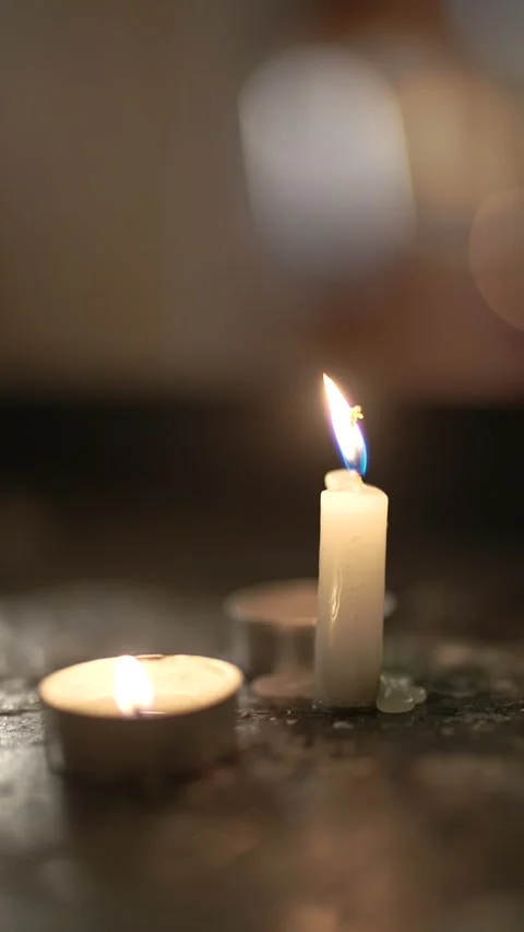 Single Burning Candle in Dim Religious Setting Stock Footage 312749829