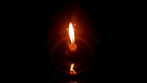 Single Burning Candle Flame in the Dark Background Stock Photos