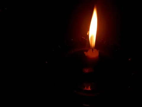 Single Burning Candle Flame in the Dark Background Stock Photos