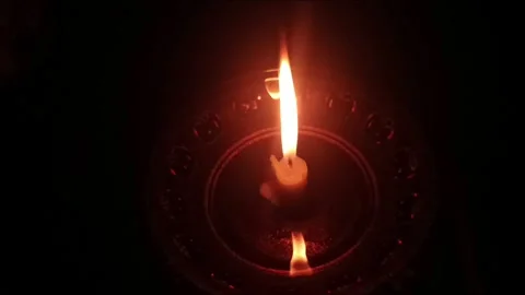 Single Burning Candle on Glass Plate in the Dark Stock Footage 333879060