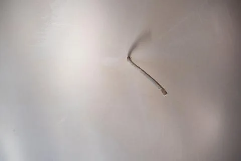 Single cable sticking out of the concrete wall Stock Photos