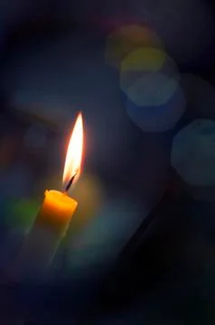 Single candle burning Stock Photos