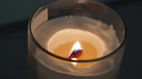 A single candle burns creating a cozy atmosphere Stock Footage 306062248
