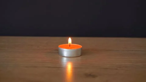 Single candle burns on the table Stock Footage 162660755