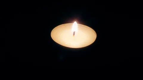Single candle flame in the dark Stock-Footage 86423366