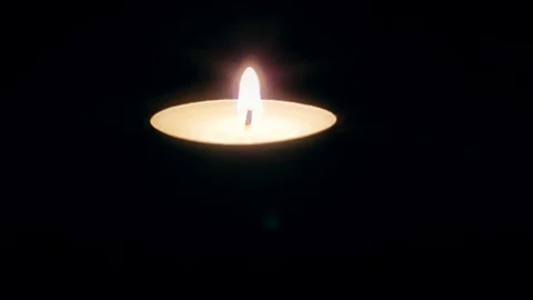 Single candle flame in the dark 스톡 동영상 86423400