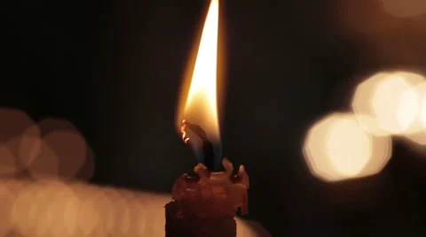 Single candle with flame fire dripping wax in church cathedral. Black macro Stock Footage 48943400