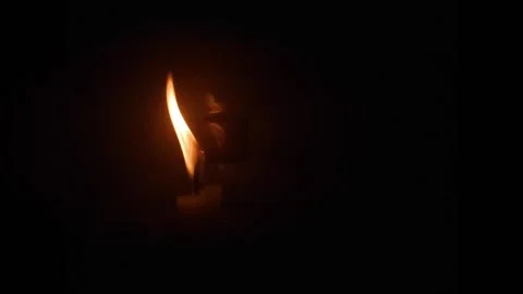 Single  candle flame lights and extinguish Stock Footage 154222472