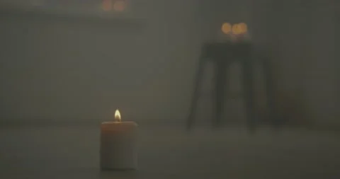 Single Candle Flickering with Other Candles in Background Stock Footage 146986035