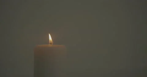 Single Candle Flickering on White Background Stock Footage 146986140